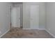 View of an empty bedroom with neutral walls and carpet and interior closet and door at 4342 Lincolndale Dr, Ellenwood, GA 30294