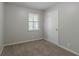 Cozy bedroom featuring neutral walls, soft carpet, and a window for natural light at 4342 Lincolndale Dr, Ellenwood, GA 30294