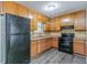 Kitchen featuring wooden cabinets, laminate countertops and black appliances at 4342 Lincolndale Dr, Ellenwood, GA 30294