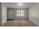 Inviting living room with plush carpet, a bright window, and a neutral color scheme at 4342 Lincolndale Dr, Ellenwood, GA 30294