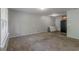 Open living room with plush carpet and natural light from a large window at 4342 Lincolndale Dr, Ellenwood, GA 30294