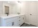 Bright bathroom featuring a double vanity with black hardware, white countertops, and gray tile floors at 4531 Moray Dr, Mableton, GA 30126