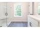 Elegant bathroom featuring a glass-enclosed shower, gray tile floors, and a vanity with white countertops at 4531 Moray Dr, Mableton, GA 30126