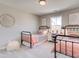Charming bedroom with two twin beds, neutral walls, decorative mirror, and natural light from the window at 4531 Moray Dr, Mableton, GA 30126