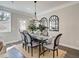 Chic dining room with statement lighting, large table, stylish chairs, and natural light at 4531 Moray Dr, Mableton, GA 30126