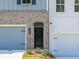 Front entrance detail showcasing brickwork, and a dark front door at 4531 Moray Dr, Mableton, GA 30126