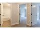 Bright hallway features access to a bedroom and bathroom with white trim and wood-look flooring at 4531 Moray Dr, Mableton, GA 30126