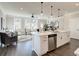 Open-concept kitchen with quartz countertop island, stainless steel appliances, and a view into the living room at 4531 Moray Dr, Mableton, GA 30126