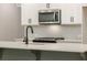 Close-up of the kitchen with modern microwave and a subway tile backsplash at 4531 Moray Dr, Mableton, GA 30126
