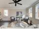 Inviting living room with black wood flooring, gray chairs, horse wall art, and abundant natural light at 4531 Moray Dr, Mableton, GA 30126