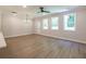 Spacious living room with large windows, hardwood floors, and a ceiling fan at 4531 Moray Dr, Mableton, GA 30126