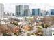 Urban aerial shot of a residential neighborhood with mixed-style homes and modern buildings against a city skyline at 774 Piedmont Ne Ave # 2A, Atlanta, GA 30308