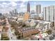 Wide aerial perspective of a residential area featuring townhouses and modern skyscrapers at 774 Piedmont Ne Ave # 2A, Atlanta, GA 30308