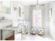Elegant bathroom with mirrored vanities, marble walls, decorative stools, and stylish lighting fixtures at 774 Piedmont Ne Ave # 2A, Atlanta, GA 30308