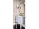 Bathroom vanity with white marble countertop, patterned wallpaper, and elegant lighting fixtures at 774 Piedmont Ne Ave # 2A, Atlanta, GA 30308