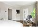 Spacious bedroom with a doorway leading to a bathroom, complemented by hardwood floors and modern decor at 774 Piedmont Ne Ave # 2A, Atlanta, GA 30308