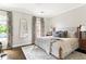 Bedroom featuring a stylish bed with decorative pillows, bedside tables, and patterned curtains at 774 Piedmont Ne Ave # 2A, Atlanta, GA 30308