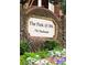 Welcoming brick sign for The Park @ 5th community with lush landscaping and vibrant flowers at 774 Piedmont Ne Ave # 2A, Atlanta, GA 30308