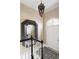 Elegant entryway with a decorative mirror, hanging pendant light, and stylish staircase at 774 Piedmont Ne Ave # 2A, Atlanta, GA 30308