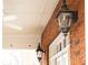 Close-up of outdoor gas lanterns against a brick wall, providing charming illumination and architectural detail at 774 Piedmont Ne Ave # 2A, Atlanta, GA 30308