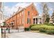 Brick townhome with drive-under garage, gated entrance, and manicured landscaping at 774 Piedmont Ne Ave # 2A, Atlanta, GA 30308