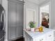 Kitchen island features marble countertop and contrasts the gray cabinetry and stainless steel refrigerator at 774 Piedmont Ne Ave # 2A, Atlanta, GA 30308