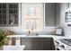 Well-lit kitchen features gray cabinets, marble countertops, stainless steel appliances, and ample counter space at 774 Piedmont Ne Ave # 2A, Atlanta, GA 30308