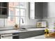 Bright kitchen featuring gray cabinets, marble countertops, subway tile backsplash, and stainless steel appliances at 774 Piedmont Ne Ave # 2A, Atlanta, GA 30308