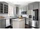 Stylish kitchen with gray cabinets, marble countertops, stainless steel appliances, and a functional island at 774 Piedmont Ne Ave # 2A, Atlanta, GA 30308