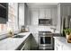 Well-lit kitchen features gray cabinets, marble countertops, stainless steel appliances, and ample counter space at 774 Piedmont Ne Ave # 2A, Atlanta, GA 30308