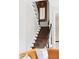 Carpeted staircase with black railings and a decorative mirror, complemented by a cozy orange sofa at 774 Piedmont Ne Ave # 2A, Atlanta, GA 30308