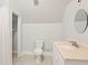 Small bathroom featuring sink, mirror, and toilet, with tile flooring and access to storage space at 789 Cooper Sw St, Atlanta, GA 30315
