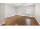Bright bedroom with beautiful hardwood floors, neutral walls, and ample natural light from the window at 789 Cooper Sw St, Atlanta, GA 30315