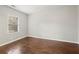 Empty bedroom featuring hardwood floors and natural light from the window at 789 Cooper Sw St, Atlanta, GA 30315
