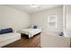 Bright, sunny bedroom with hardwood floors, featuring twin beds and a comfortable sitting area at 789 Cooper Sw St, Atlanta, GA 30315