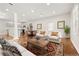 Bright and airy living room with hardwood floors, neutral walls, and stylish furniture and adjacent kitchen area at 789 Cooper Sw St, Atlanta, GA 30315
