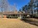 Charming single-story home with a covered front porch and well-manicured landscaping at 440 Ward Rd, Ellenwood, GA 30294