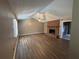 Spacious living room with vaulted ceiling, hardwood floors, and a brick fireplace at 440 Ward Rd, Ellenwood, GA 30294