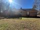 Back of home with wooden deck, siding, and a spacious grassy yard at 440 Ward Rd, Ellenwood, GA 30294