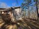 Side view of home featuring wood siding, brick accents, and a fenced backyard at 440 Ward Rd, Ellenwood, GA 30294