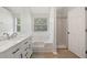 Bright bathroom with double vanity, marble countertop, bathtub, and a separate shower room at 4832 Hidden Creek Pl, Decatur, GA 30035