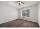 Bedroom with neutral walls, carpet floors, a trey ceiling, a ceiling fan with light fixture, and a window at 4832 Hidden Creek Pl, Decatur, GA 30035