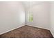 This bedroom features neutral walls, brown carpet and a bright window at 4832 Hidden Creek Pl, Decatur, GA 30035