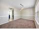 Bright dining room featuring neutral tones, a modern lighting fixture, and plush brown carpeting at 4832 Hidden Creek Pl, Decatur, GA 30035