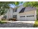 Side view of this lovely two-story house featuring a two-car garage and well-maintained landscaping at 4832 Hidden Creek Pl, Decatur, GA 30035