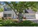 Beautiful two-story house showcasing gray shutters, a white front door, well-manicured landscaping, and an attached garage at 4832 Hidden Creek Pl, Decatur, GA 30035