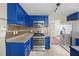 Modern kitchen with stainless steel appliances, blue cabinetry, and mosaic backsplash at 4832 Hidden Creek Pl, Decatur, GA 30035