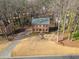 An aerial view of a two-story brick home with a large front yard and long driveway at 505 Summer Ter, Woodstock, GA 30189