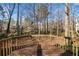 A wood deck with a wooden railing looks out over a wooded area at 505 Summer Ter, Woodstock, GA 30189