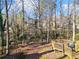 View of the backyard, including a wooden deck, play area, and mature trees at 505 Summer Ter, Woodstock, GA 30189